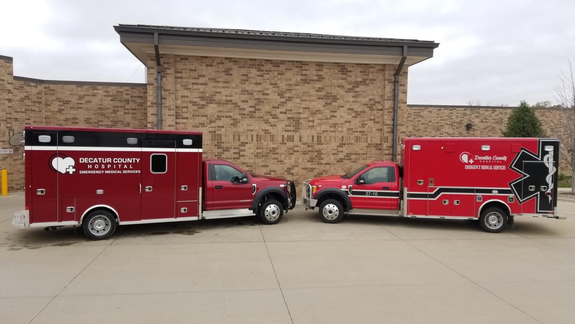 Two ambulances from the Decatur County Hospital EMS service are pictured together.