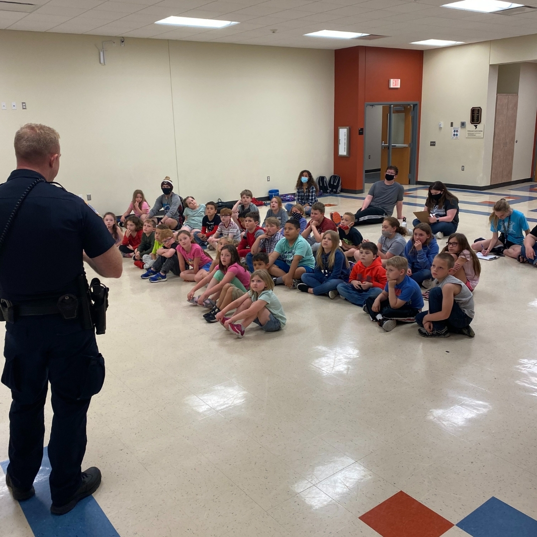 Mark Mattes, Chief Nursing Officer at Decatur County Hospital, fits helmets on students from the Lamoni Exploration Academy.