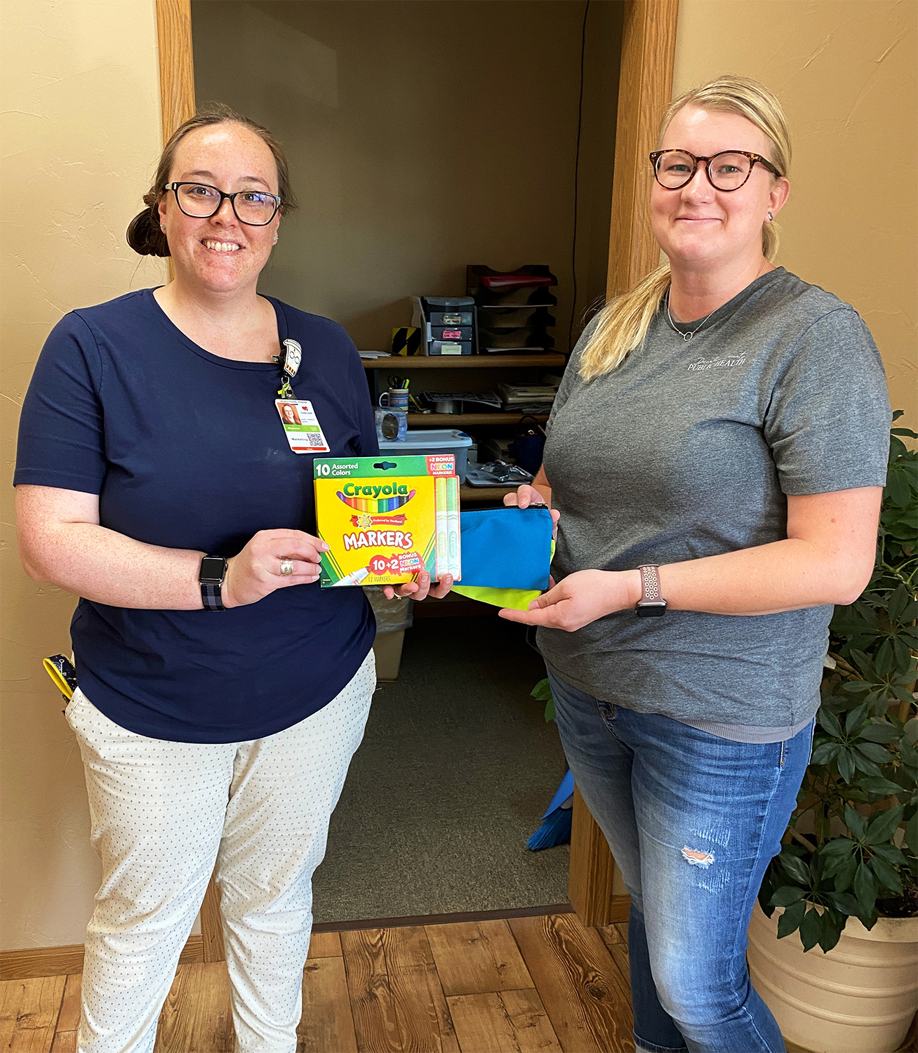 Shannon Erb, DCH Director of Marketing and Business Development, presents Holly Rash, Decatur County Publish Health Administrator, with school supplies for the Decatur County Back to School Event on August 10, 2021.