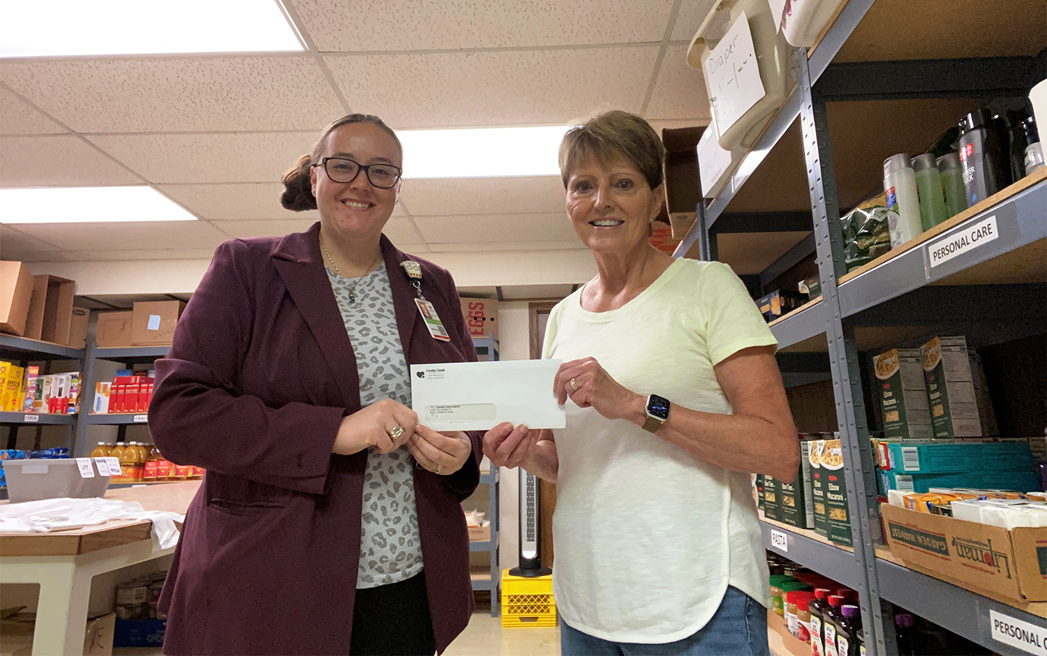 Shannon Erb, DCH Director of Marketing and Business Development, presents Gwen Simpson, Lamoni Food Pantry Manager, with a check for $600 to support the purchase of school supplies for the Lamoni School District.