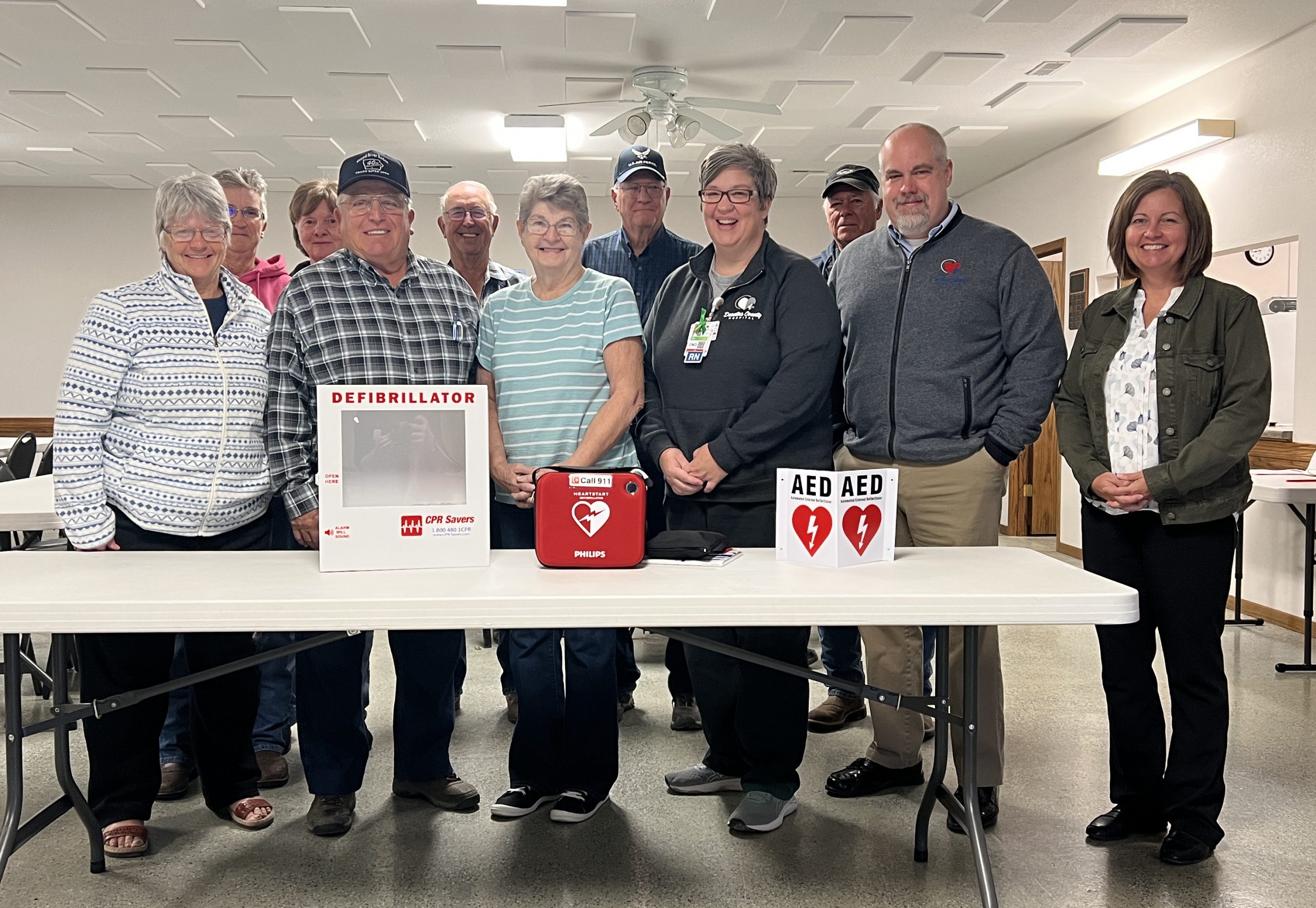 grand river aed presentation-group Decatur County Hospital Board Member Larry Griffin (second from left in the front row), along with staff members (starting fourth from the left in the front row) Kelly Barker, CNO; Mike Johnston, CEO; and Tara Spidle, CFO, present a defibrillator (AED) to the Grand River Community Center.