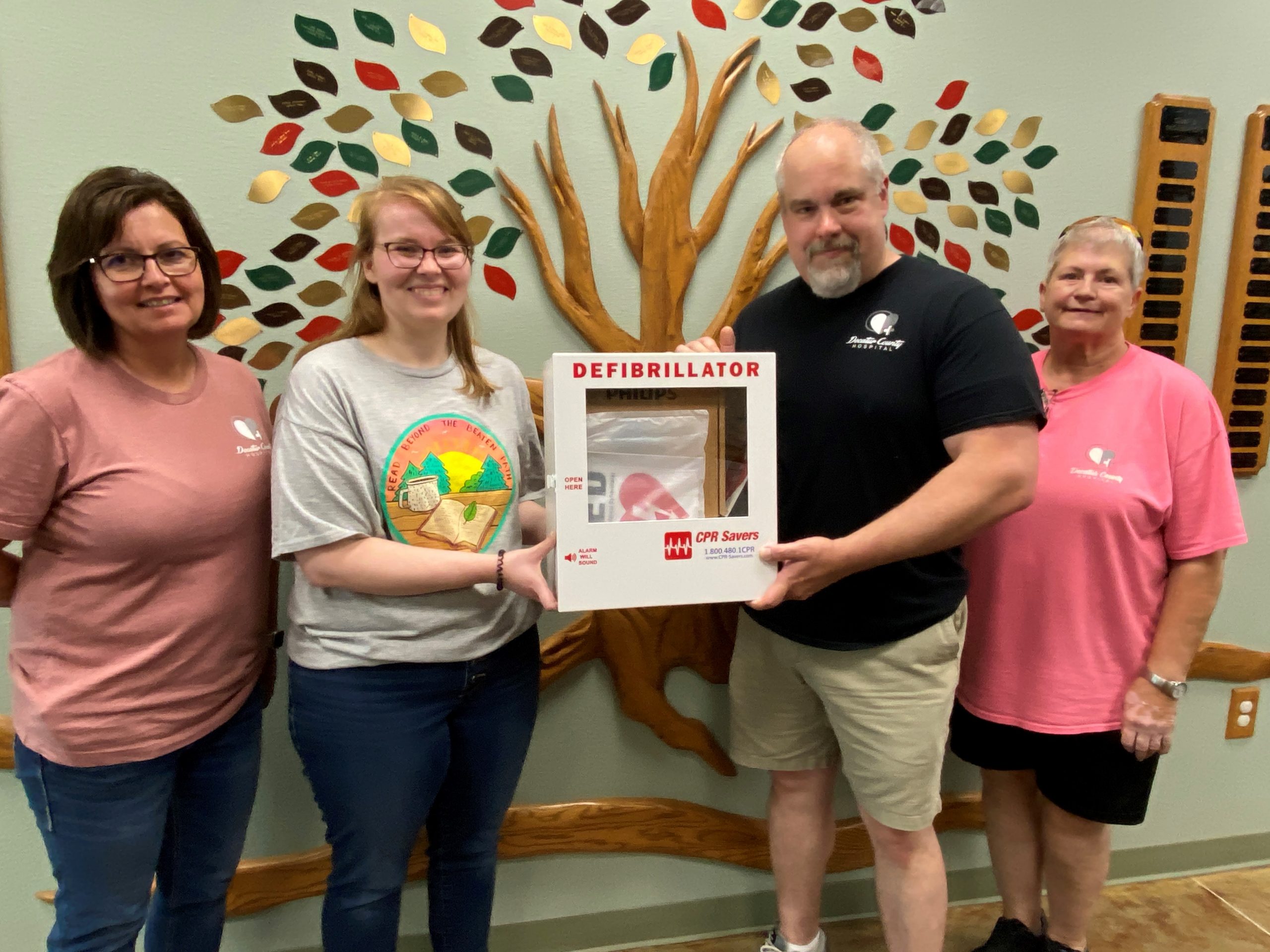 Decatur County Hospital presents a defibrillator (AED) to the Lamoni Public Library. Pictured l-r: Tara Spidle, DCH CFO; Felicia Williams, Director, Lamoni Public Library; Mike Johnston, DCH CEO; Denise Elefson, DCH Board of Trustees Chair and Lamoni EMS Chair.